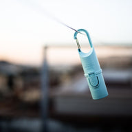 Ridge Capsule clipped to a pack strap